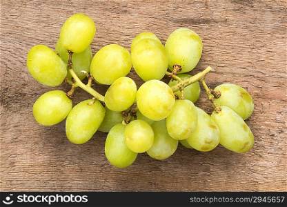Fresh grapes on rustic wooden background