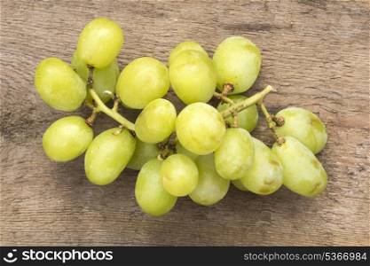 Fresh grapes on rustic wooden background. Macro image of fresh grapes
