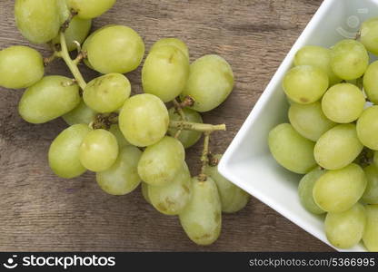 Fresh grapes on rustic wooden background. Macro image of fresh grapes