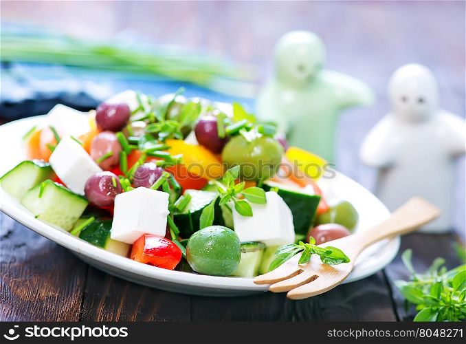 fresh greek salad in the white plate
