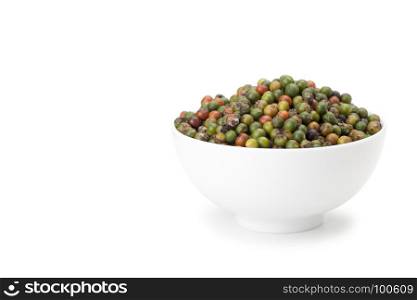 fresh green and orange peppercorns in white ceramic bowl on white background with clipping path
