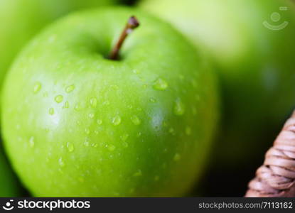 Fresh green Apples / harvest apple in the basket in the garden fruit nature green background