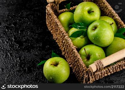 Fresh green apples in a basket. On a black background. High quality photo. Fresh green apples in a basket.
