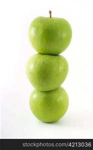 Fresh green apples stacked on top of one another