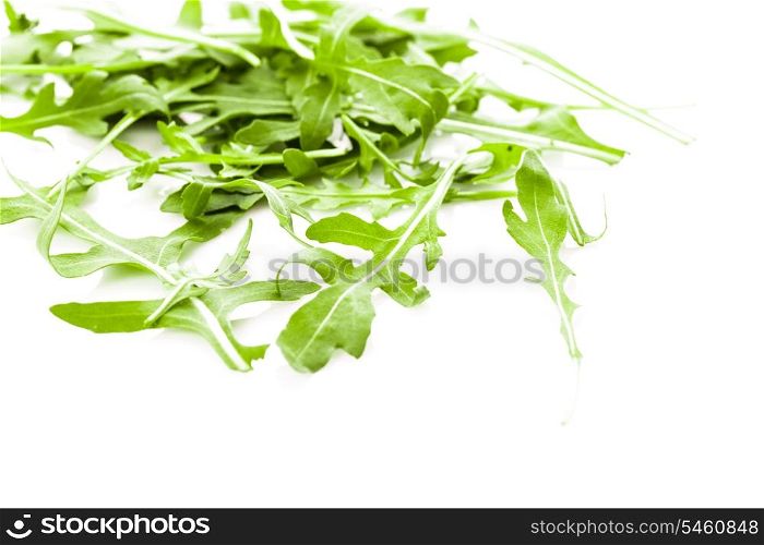Fresh green arugula heap isolated on white