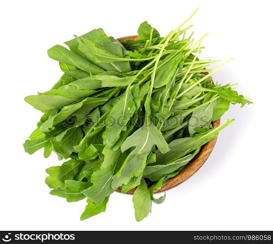 Fresh green arugula leaves on wooden bowl isolated on white background. Fresh green arugula leaves on wooden bowl,