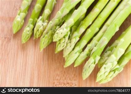 Fresh green Asparagus bundle on wooden background
