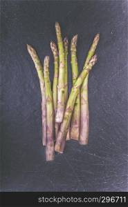 Fresh green asparagus on a slate platter