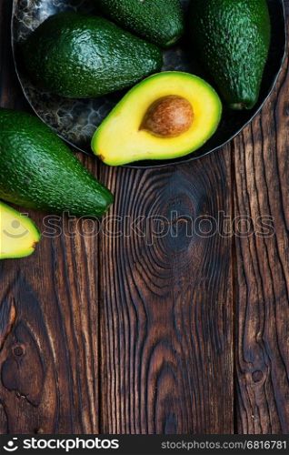 fresh green avocado on the wooden table