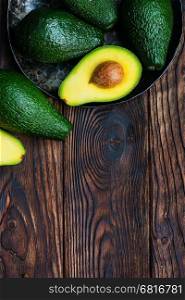 fresh green avocado on the wooden table