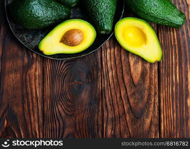 fresh green avocado on the wooden table