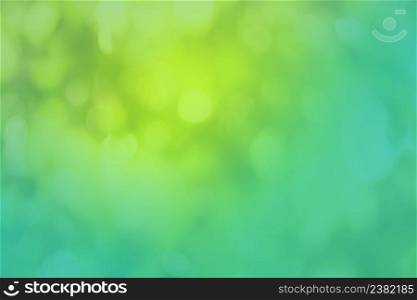 Fresh green background with abstract blurred foliage. Natural green background.. Abstract green blurred background under the bright sun. Green nature blurred background