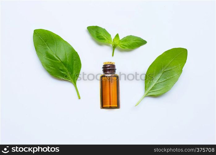 Fresh green basil leaves with essential oil isolated on white