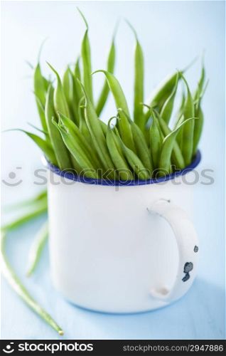 fresh green beans in white cup