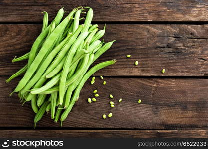 Fresh green beans on dark wooden rustic background top view copy space flat lay