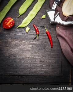 Fresh green beans with chili and tomato, rustic food background, top view