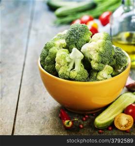 Fresh green broccoli and Healthy Organic Vegetables on a Wooden Background.