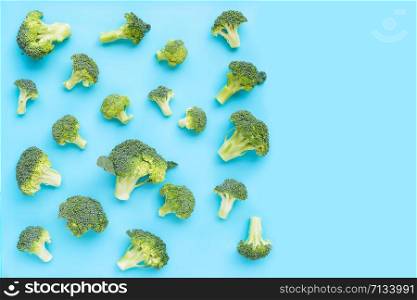 Fresh green broccoli on blue background. Copy space