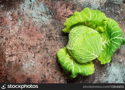 Fresh green cabbage. On rustic background. Fresh green cabbage.