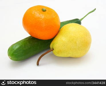 Fresh green cucumber with a tangerine and a pear lie on a white background