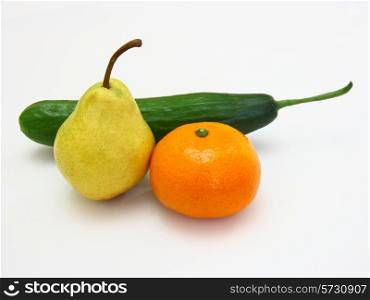 Fresh green cucumber with a tangerine and a pear lie on a white background