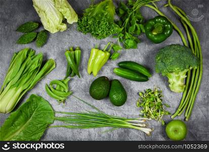 Fresh green fruit and green vegetables mixed background , top view various for healthy food vegan cook / Healthy food selection clean eating for heart life cholesterol diet health concept