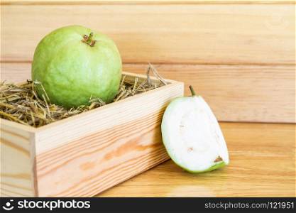 Fresh green goiaba on a wooden box