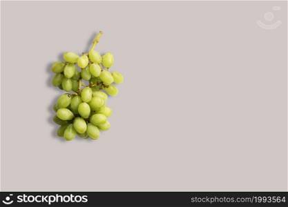 Fresh green grapes on a white background for the menu. Geometric background. Flat lay, copy space, top view.