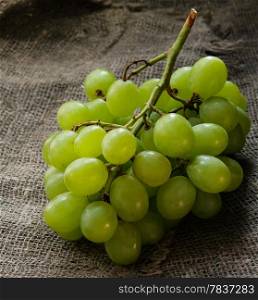 Fresh green grapes over rustic background, selective focus