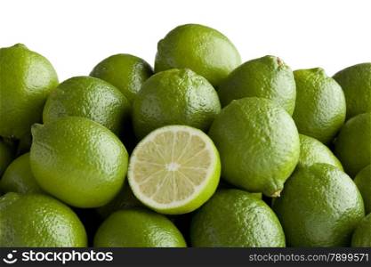 Fresh green limes and a half one