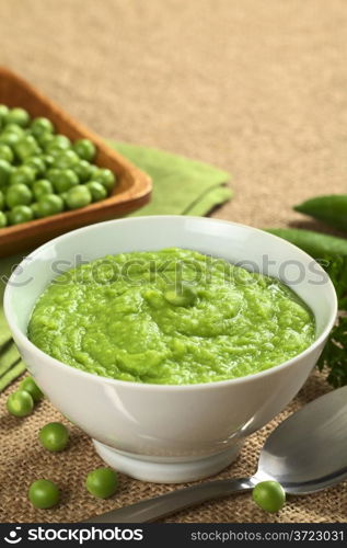 Fresh green pea soup with copy space (Selective Focus, Focus on the pea in the middle of the soup)