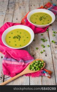 Fresh green pea soup with pea seeds. Cream soup of green peas. A delicious lunch in a rustic style
