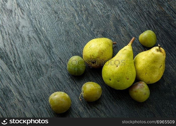 fresh green pears in black wooden background. fresh green pears