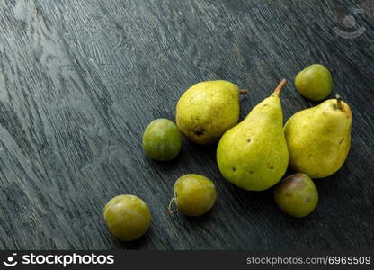 fresh green pears in black wooden background. fresh green pears