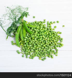 Fresh green peas in a bowl on a white table. Fresh Green Peas