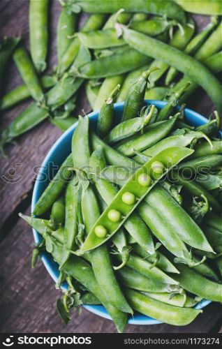 Fresh green peas on a wooden table