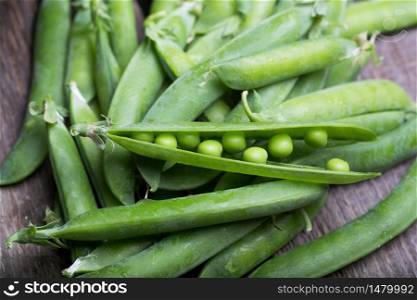 Fresh green peas on a wooden table