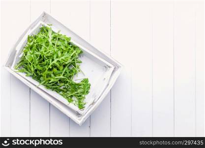 fresh green salad arugula rucola on a White background shabby