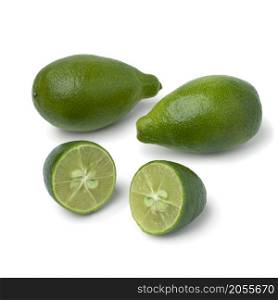 Fresh green whole and halved limequat close up isolated on white background