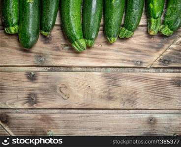 Fresh green zucchini. On wooden background. Fresh green zucchini.