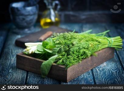 fresh greens in wooden bx and on a table
