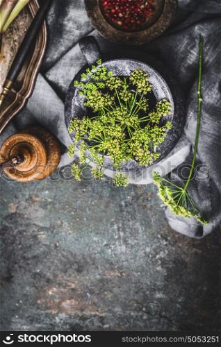 Fresh greens seasoning in jug , cooking preparation on dark rustic kitchen table background, top view
