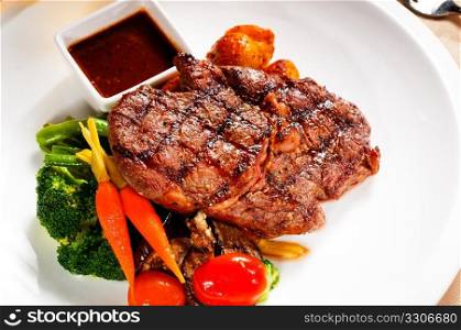fresh grilled ribeye steak with broccoli,carrot and cherry tomatoes on side