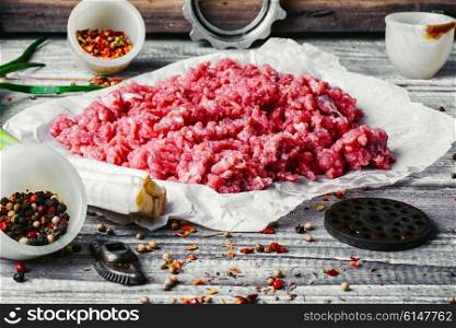 Fresh ground beef with spices on paper for baking. Raw minced beef