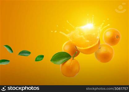 Fresh half of ripe Orange fruit splashing on orange background