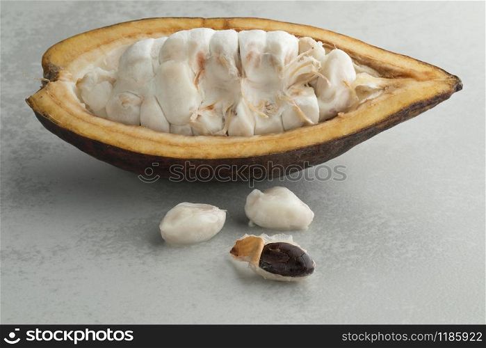 Fresh halved cocoa fruit with raw cocoa beans visible