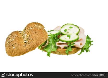 Fresh ham and cucumber sandwich over white background