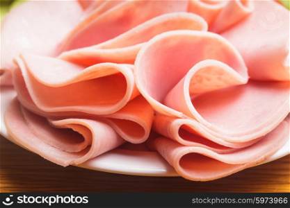 Fresh ham slices on the white plate. The Ham slices