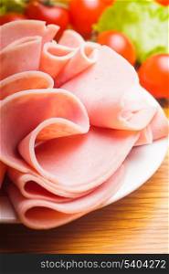 Fresh ham slices with lattuce and cherry tomato on the plate