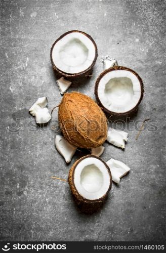 Fresh hard coconuts. On a stone background.. Fresh hard coconuts.